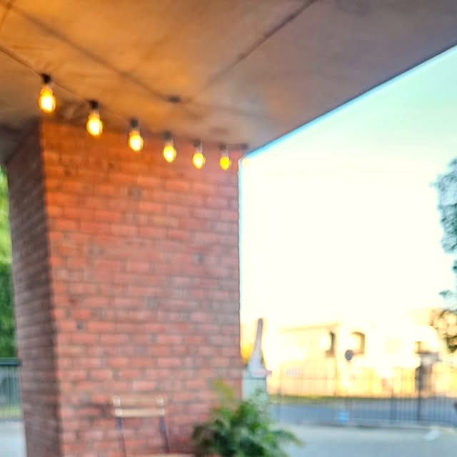 The Bloom stoep under string lights